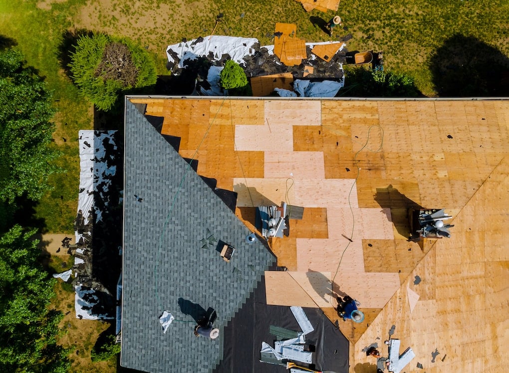 Overhead view of contractors replacing roof