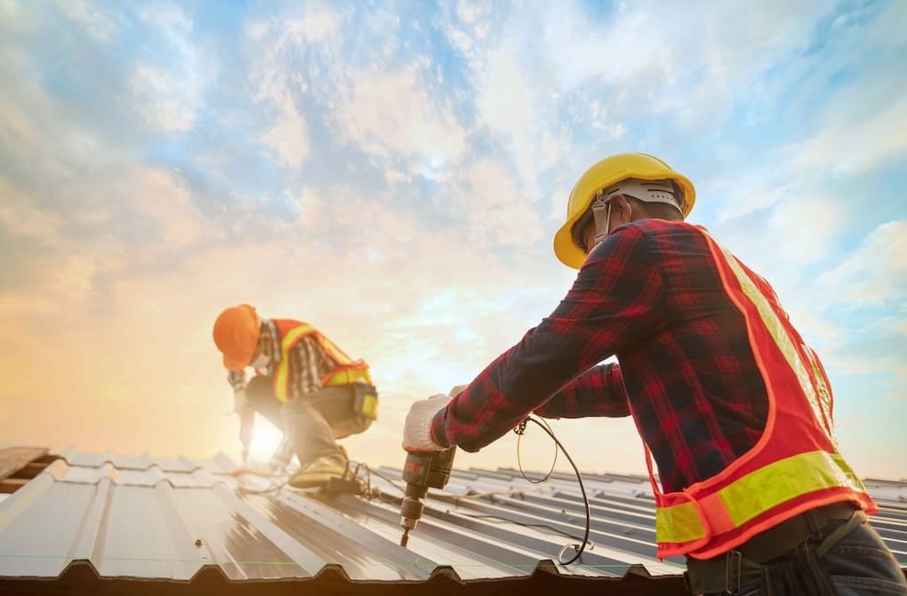 Commercial Roofing Job with Contractors Bolting Metal