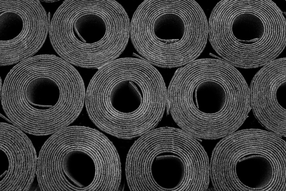 Closeup of Rolls of new black roofing felt or bitumen; diy roofing