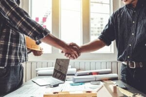 Contractor shaking hands with roofing customer