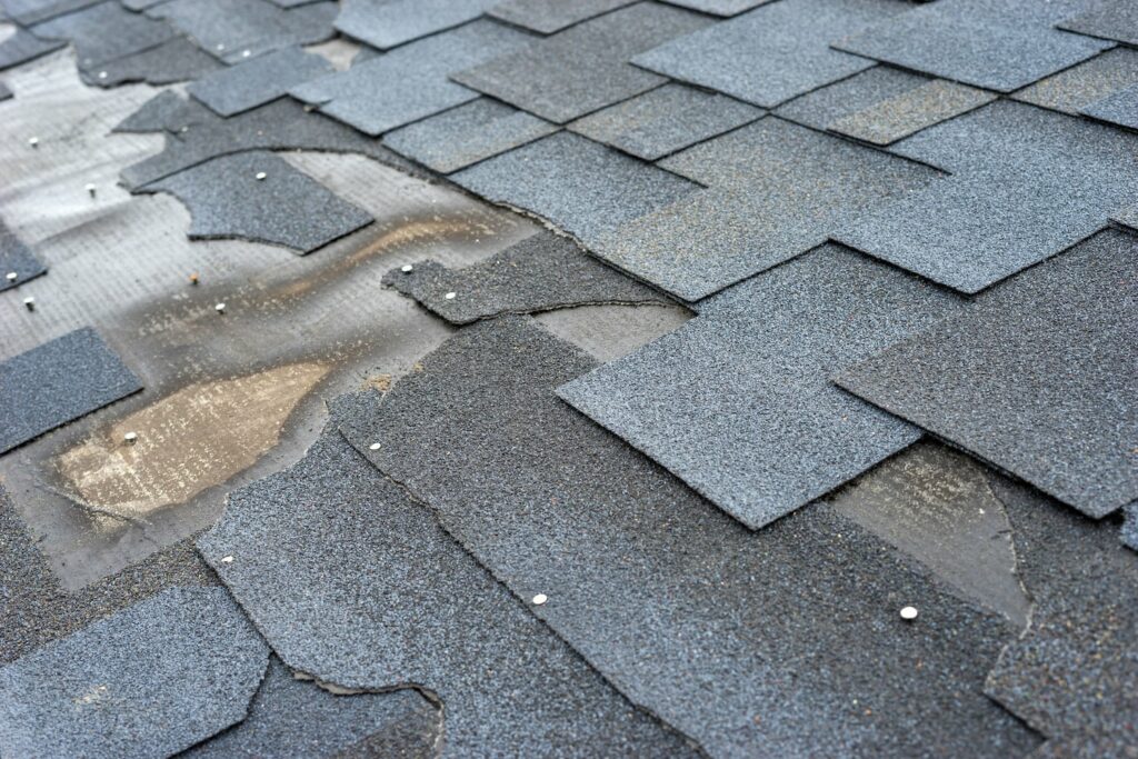 missing shingles show signs of roof damage from a storm