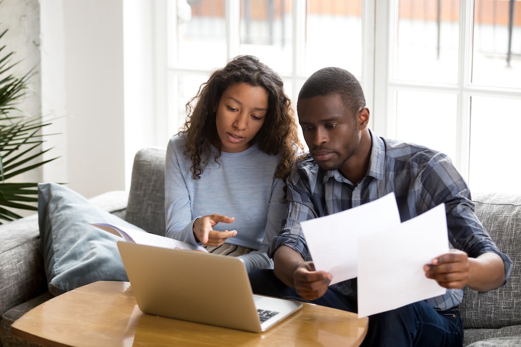 couple reviewing insurance before roof claim 