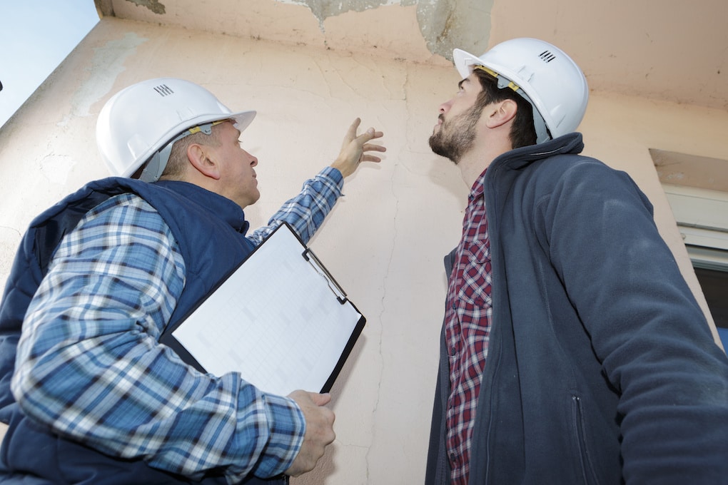 Building inspection reviewing roof damage