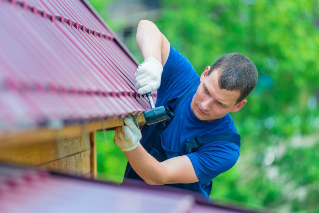 Roofing contractor replacing metal roof