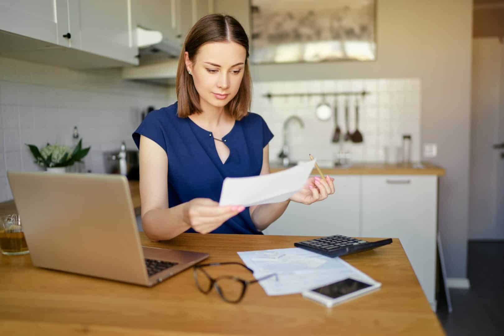 woman reviewing cooling costs on her utility bill