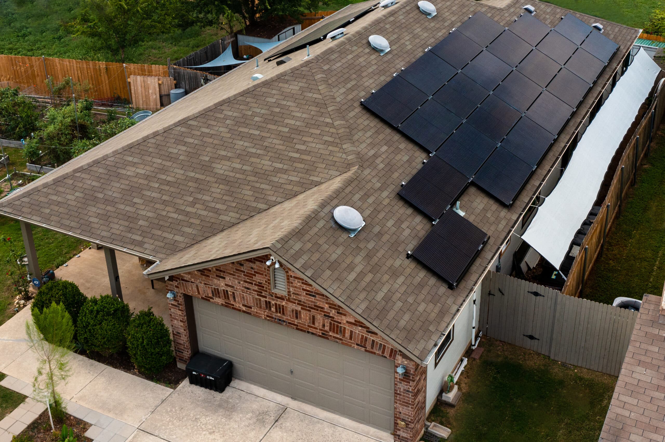 Brown roof featuring stylish black solar panels.