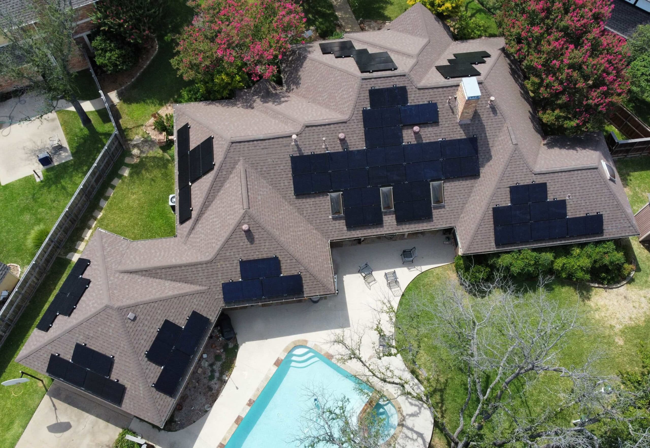 Grey solar roof with sleek black solar panels, captured from a drone's bird's-eye view.