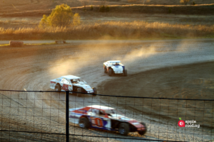 Cars racing on dirt track