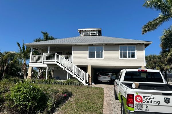 Apple Roofing truck parked in a Florida home's driveway